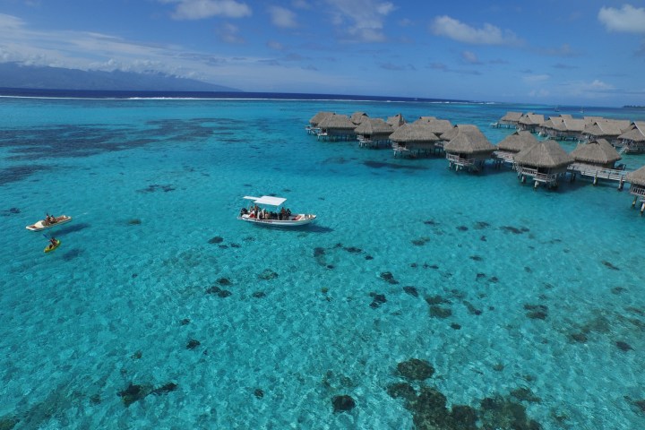 a sandy beach next to a body of water