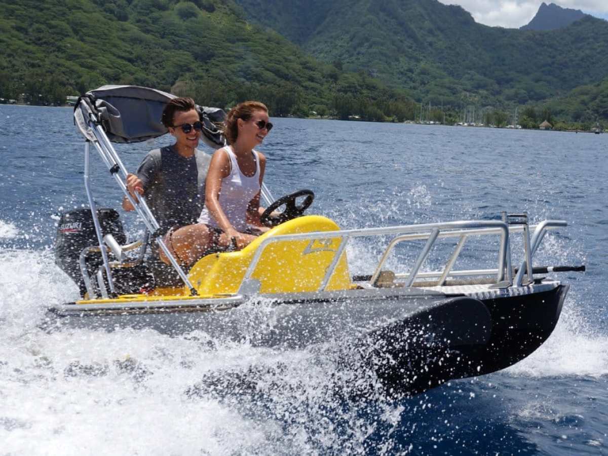 a man riding on the back of a boat in the water