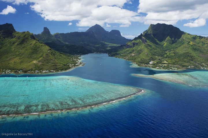 a body of water with a mountain in the background